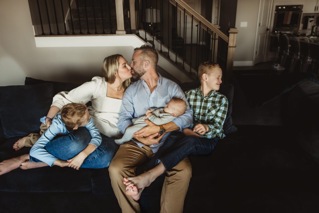 In-home newborn photography session highlighting the bond between mother and baby, as they navigate emotions together in a calm, supportive environment.